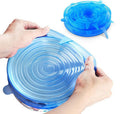 Blue silicone lid being stretched over a container by hands on a white background