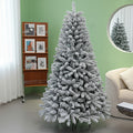 Frosted Christmas tree in a room with a bookshelf and mirror.