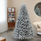 Frosted Christmas tree in a living room setting with a bookshelf and sofa.