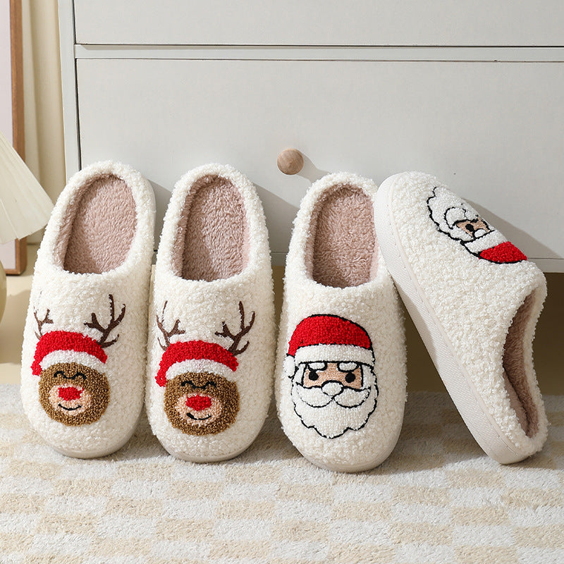 Four pairs of white slippers with Santa and reindeer designs on a light background.