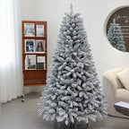Frosted Christmas tree in a living room setting with a bookshelf and sofa.