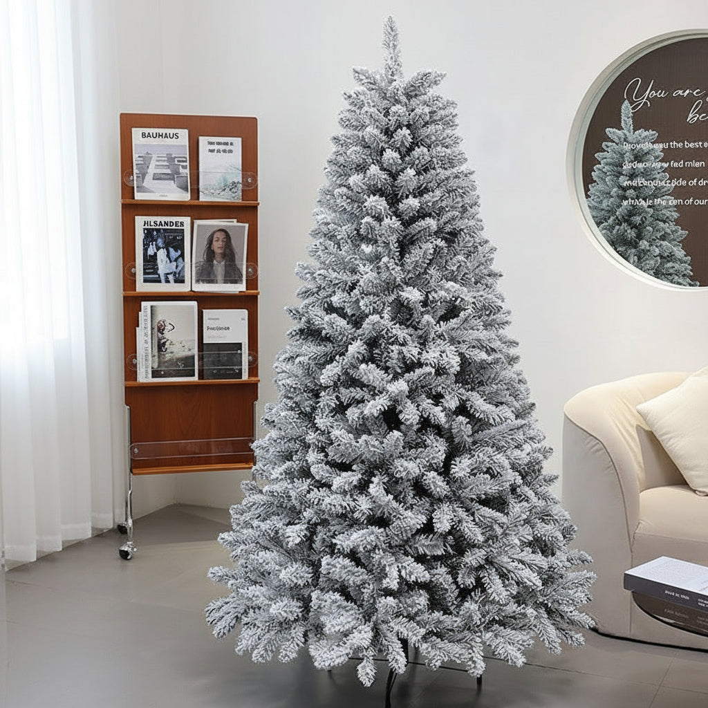 Frosted Christmas tree in a living room setting with a bookshelf and sofa.