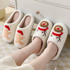 White slippers with Christmas-themed designs on a soft surface