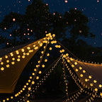String lights decorating a tent with battery and USB options on a dark night sky background.